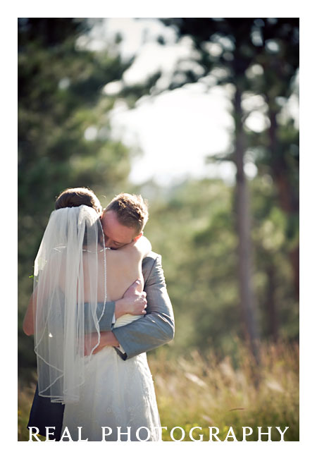 bride and groom hug after first look on wedding day