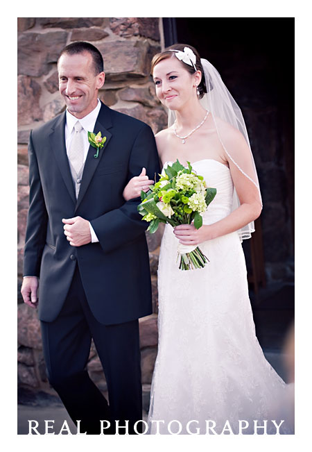 father and daughter walk down aisle