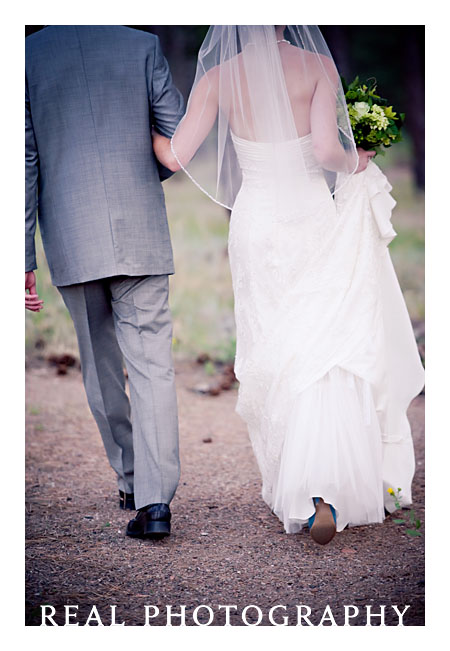 bride and groom walk down path