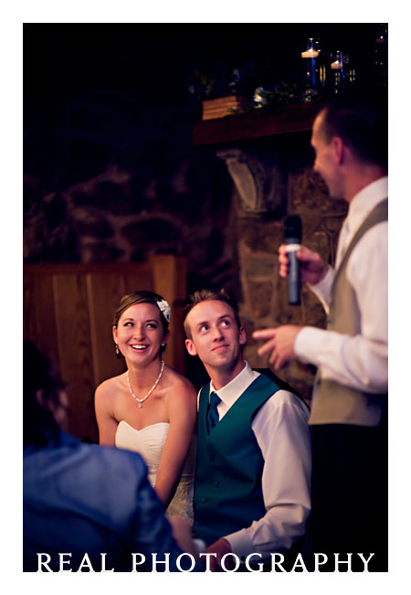 bride and groom during toasts at wedding reception