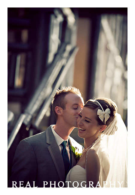 bride laughing with groom outside boettcher mansion