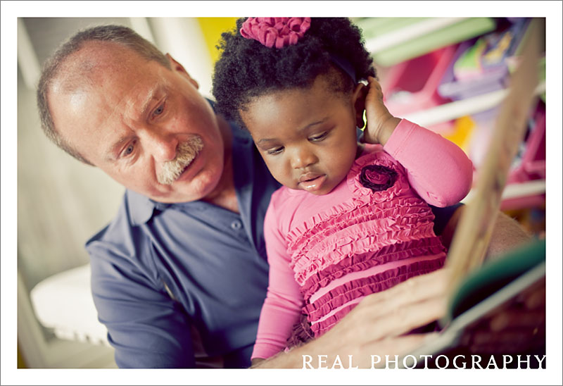 grandpa reading with granddaughter