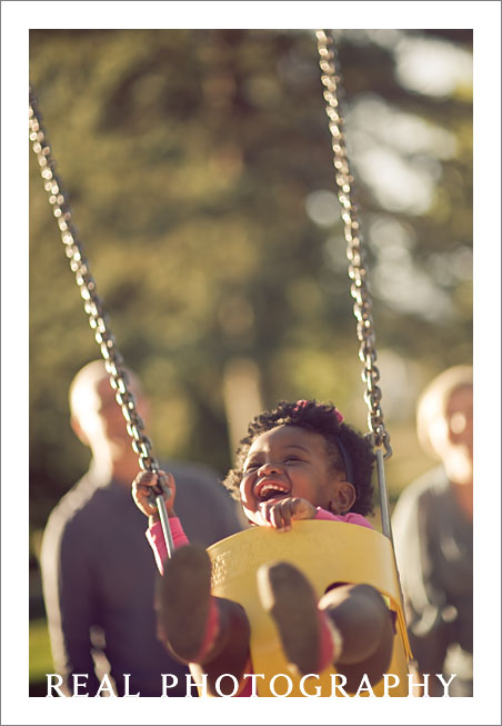 baby swinging with mom and dad parents family photographer colorado springs