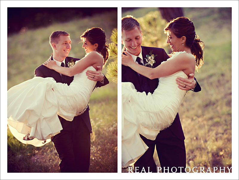 groom carries bride in sunset wedding outside lodge at cathedral pines